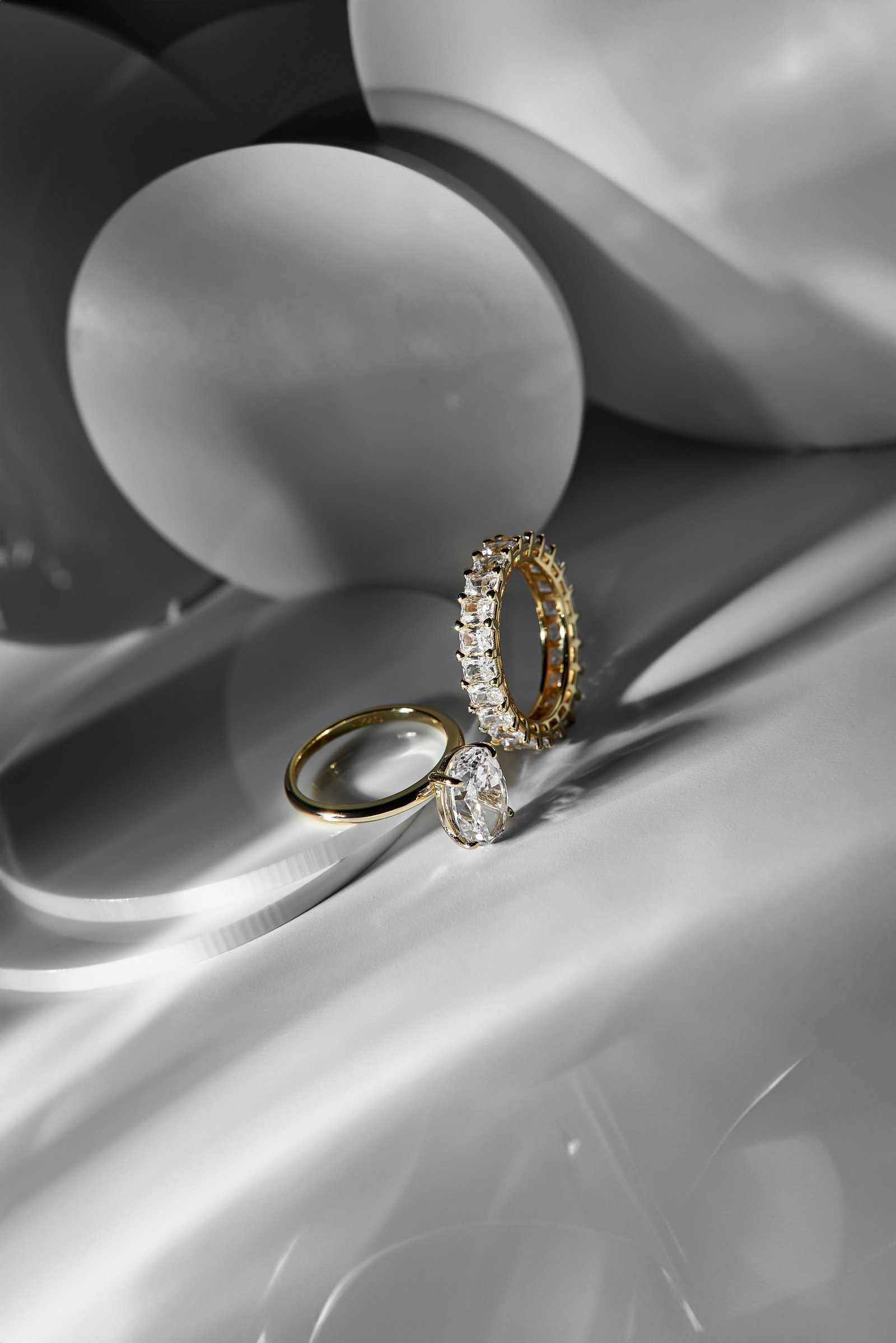 Two gold rings resting on sculpted porcelain